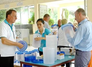 Rotarians and friends assemble the water filters in preparation to donate them to the school.